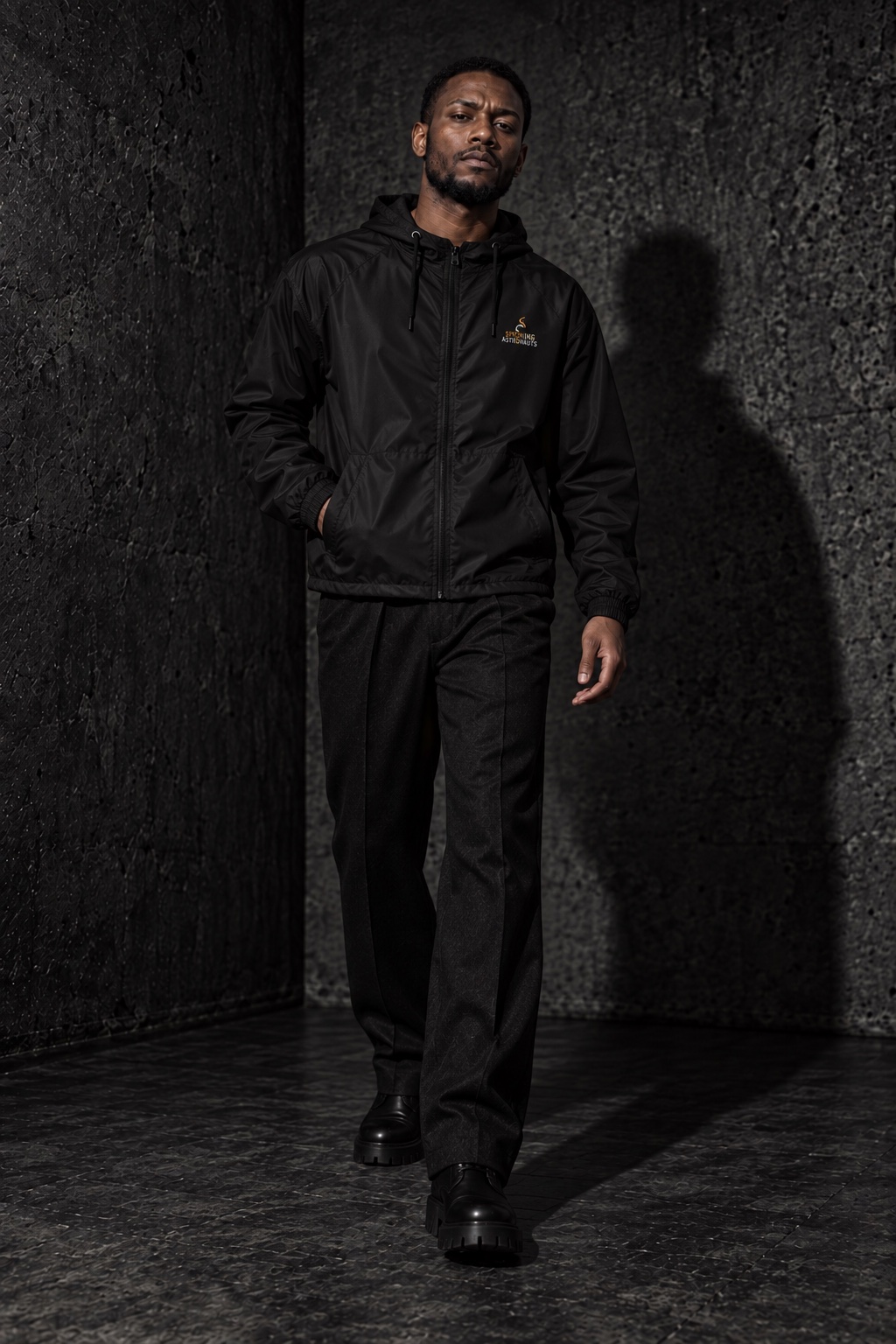AI styling concept: adult man walking in a black Stellar Voyager windbreaker, black trousers and black boots