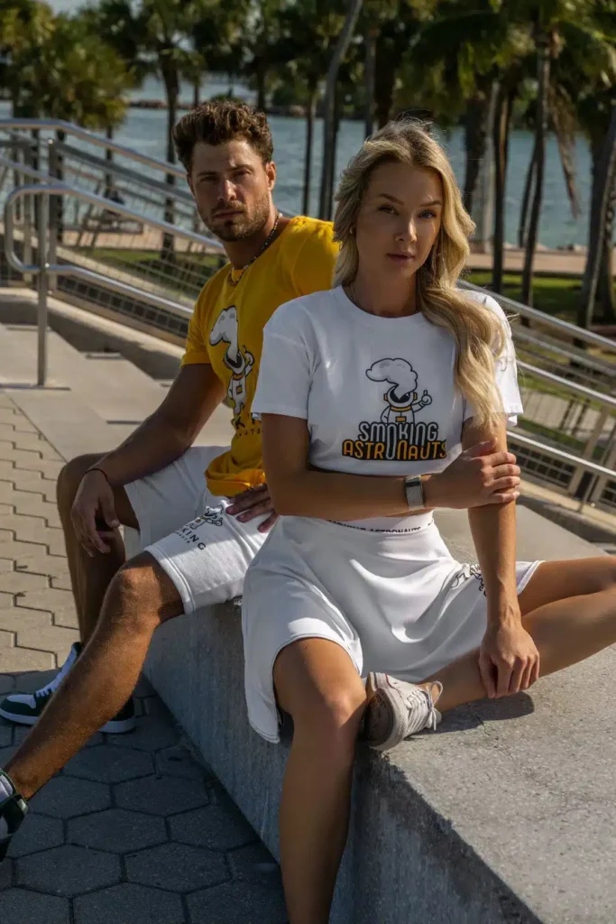 Two models in original Smoking Astronauts pieces beside waterfront steps